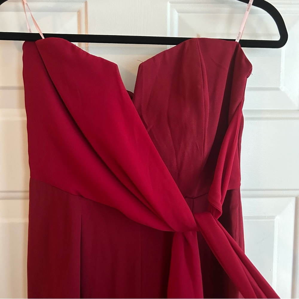Dark red sleeveless jumpsuit with bow
